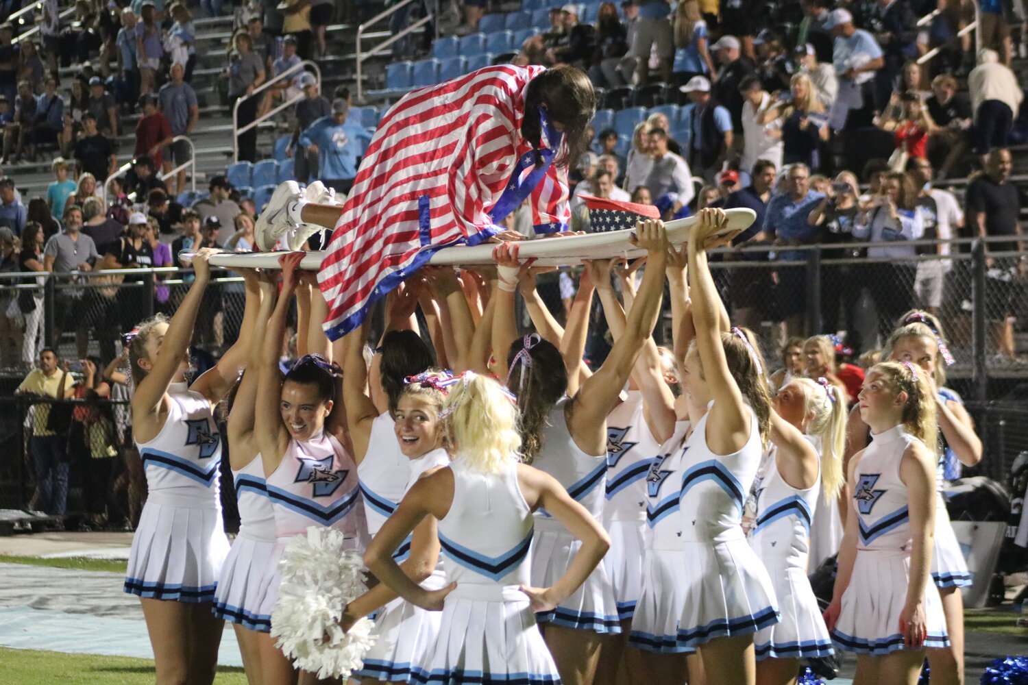 Ponte Vedra High cheerleaders root on one of their own as she does 35 pushups, one for each point scored on the night.